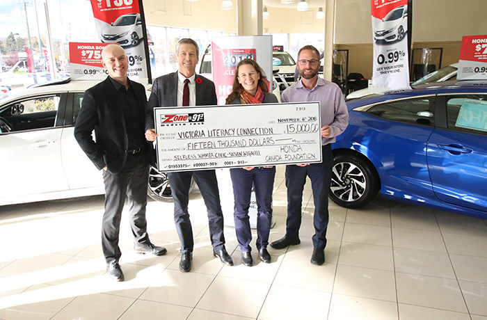 Members of the Victoria Literacy Connection receive a large cheque.