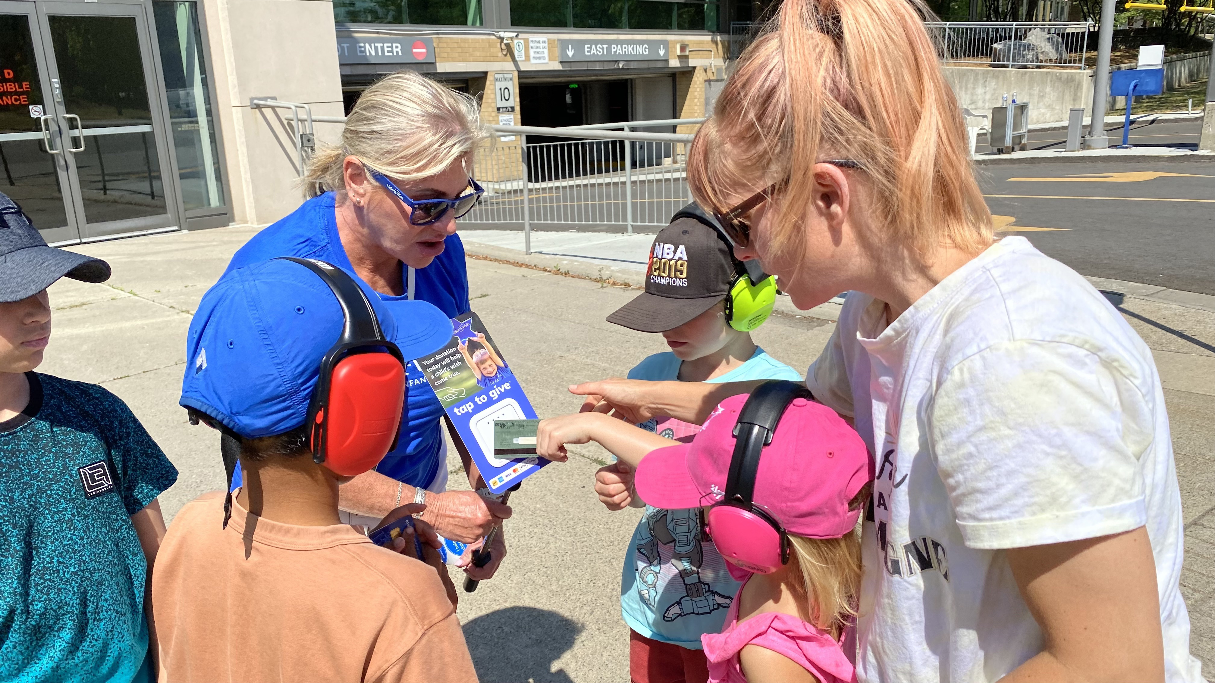 Une bénévole de Rêves d’enfants accepte un don d’amateurs de course